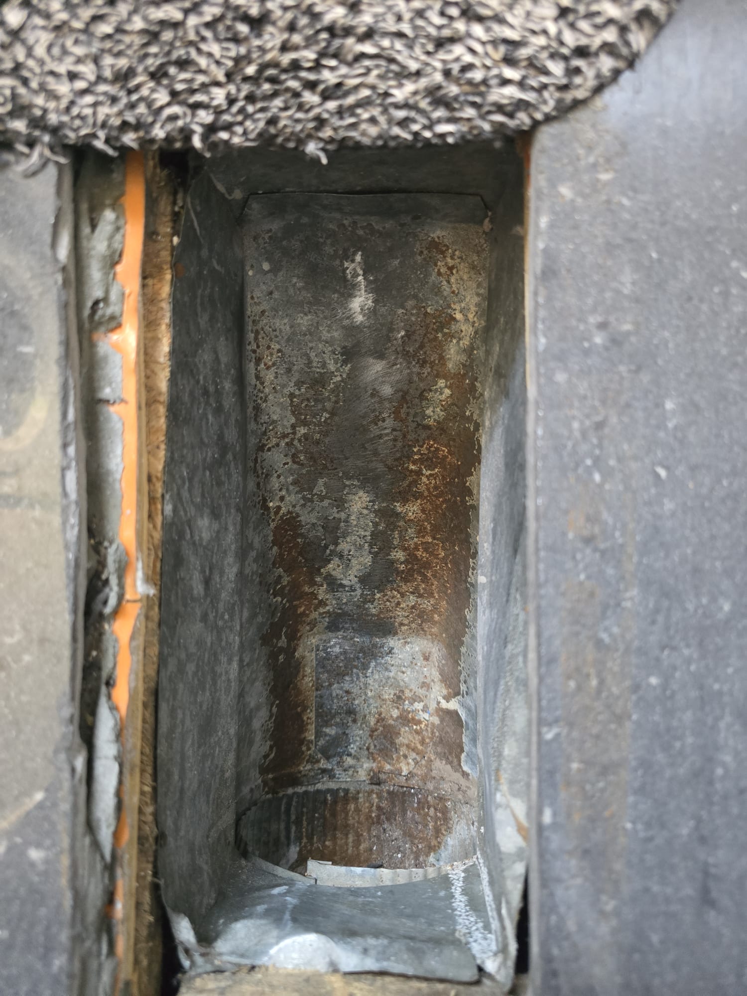 Rusted, corroded duct interior before restoration and painting